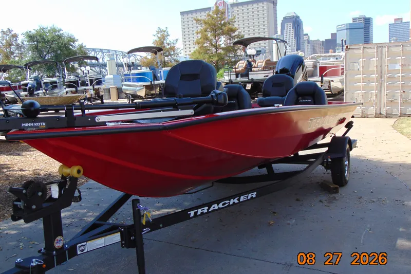 Slide: The Image of 2026 Tracker Pro Team 190 boat in vibrant red on trailer, urban backdrop. - 14
