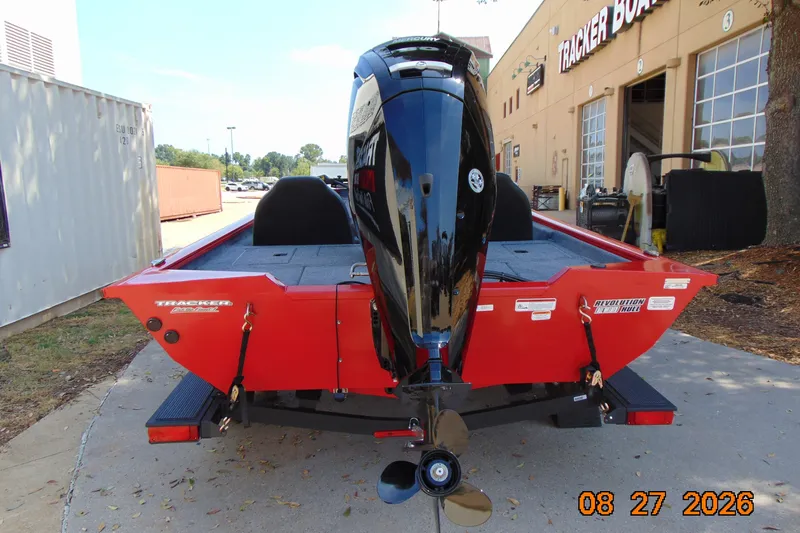 Slide: The Image of 2026 Tracker Pro Team 190 boat with outboard motor, parked outside dealership. - 70