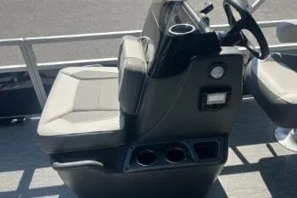 Slide: The Image of 2026 Sun Tracker Bass Buggy 16 XL Select boat console with steering wheel and seating. - 5