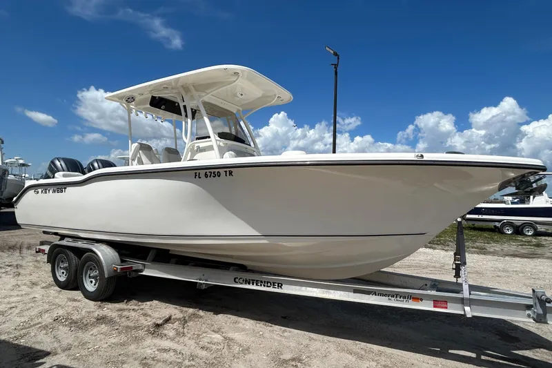 The Image of 2024 Key West 263 FS boat on trailer under clear blue sky. - 0