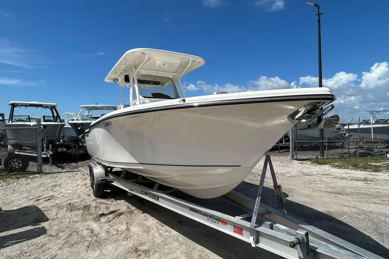 Slide: The Image of 2024 Key West 263 FS boat on trailer under clear blue sky. - 1