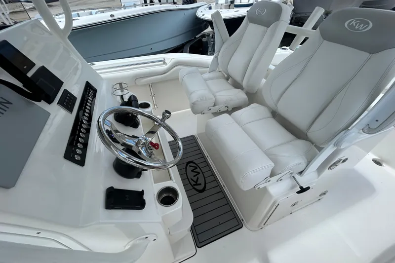 Slide: The Image of 2024 Key West 263 FS boat interior with white seating and steering console. - 10