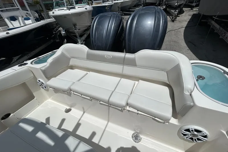 Slide: The Image of 2024 Key West 263 FS boat interior with cushioned seating and built-in speakers. - 12