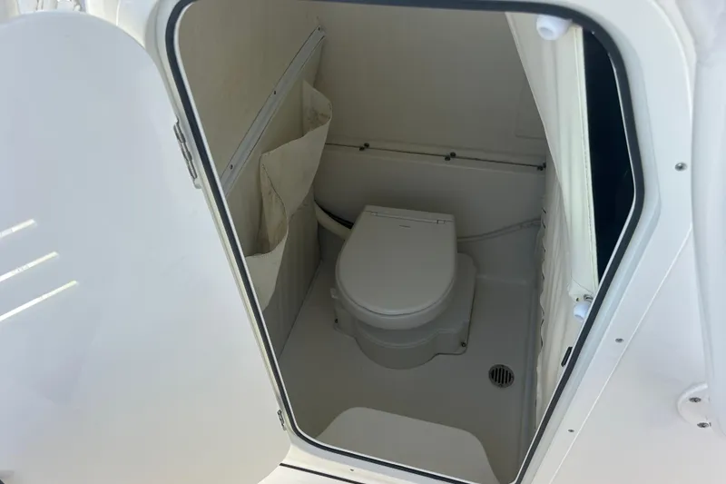Slide: The Image of 2024 Key West 263 FS boat interior with compact marine toilet. - 17