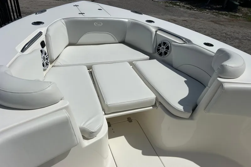 Slide: The Image of 2024 Key West 263 FS boat interior with white cushioned seating and built-in speakers. - 18