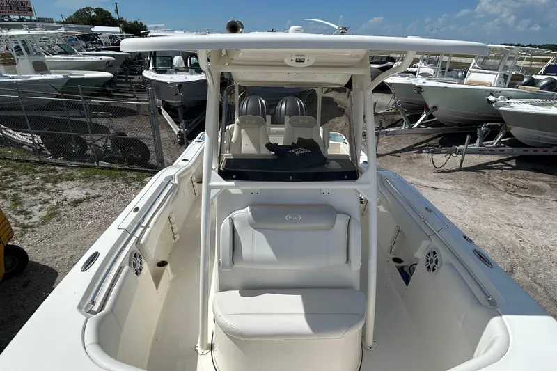 Slide: The Image of 2024 Key West 263 FS boat with spacious seating and modern design in a marina setting. - 19