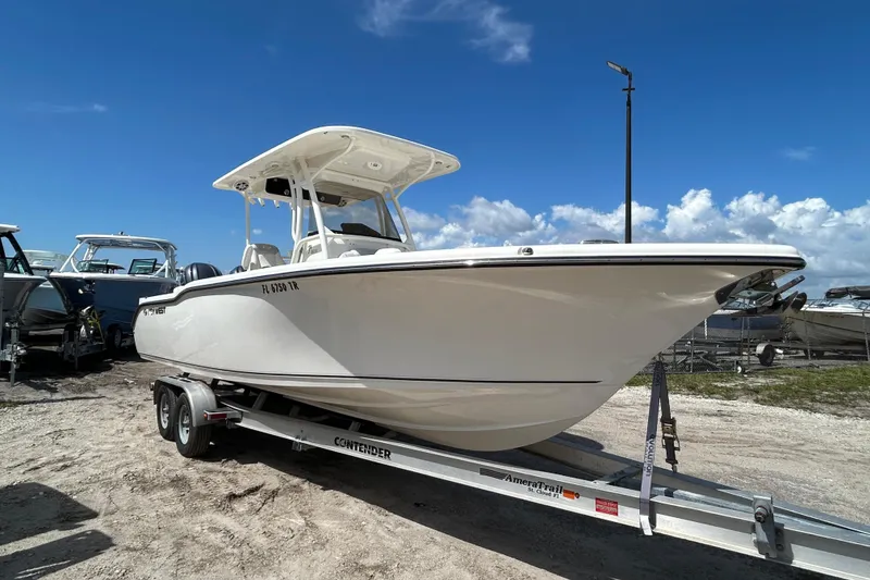 Slide: The Image of 2024 Key West 263 FS boat on trailer under clear blue sky. - 2