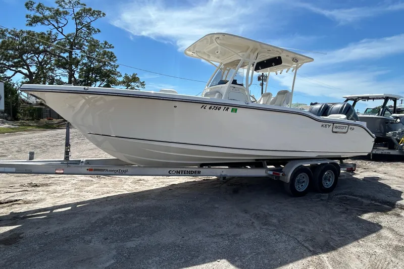 Slide: The Image of 2024 Key West 263 FS boat on trailer under clear blue sky. - 3