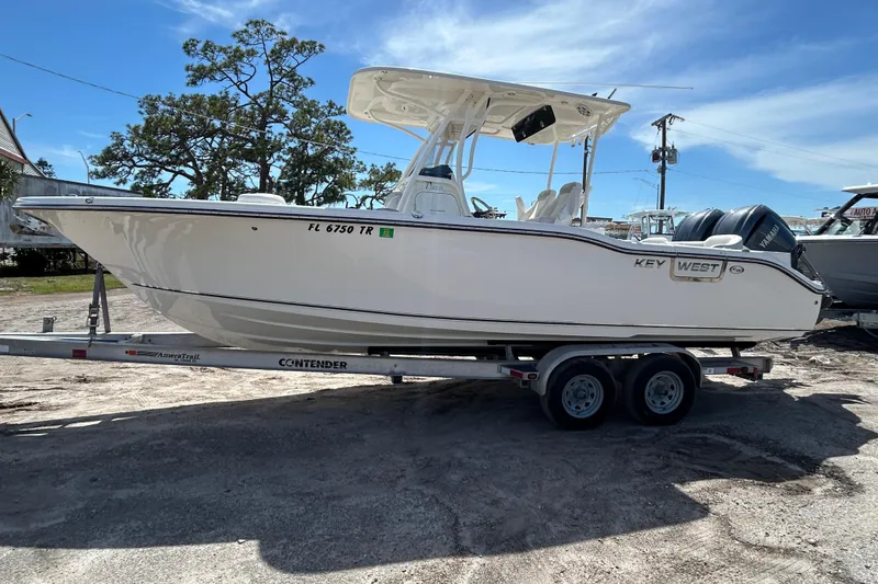Slide: The Image of 2024 Key West 263 FS boat on trailer, side view, outdoors. - 4