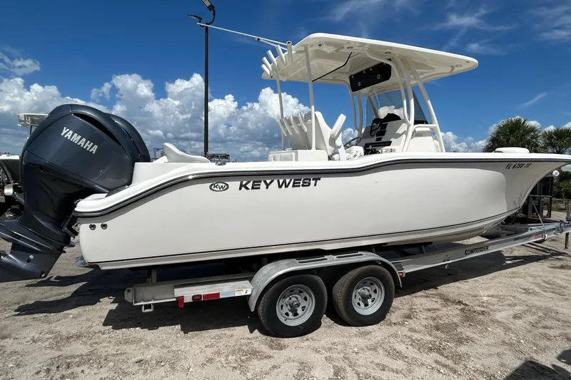 Slide: The Image of 2024 Key West 263 FS boat on trailer with Yamaha engine, under clear blue sky. - 5