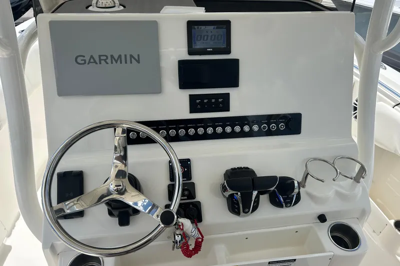 Slide: The Image of 2024 Key West 263 FS boat dashboard with Garmin navigation system and steering wheel. - 7