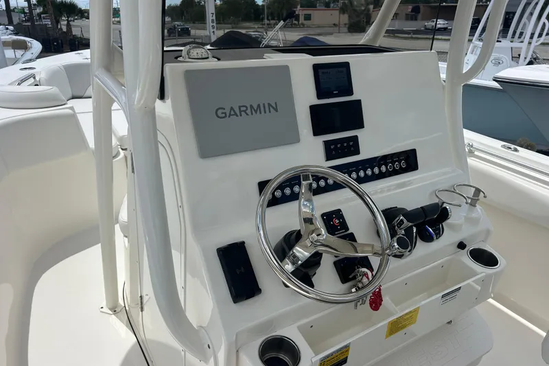 Slide: The Image of 2024 Key West 263 FS boat dashboard with Garmin navigation system and steering wheel. - 9