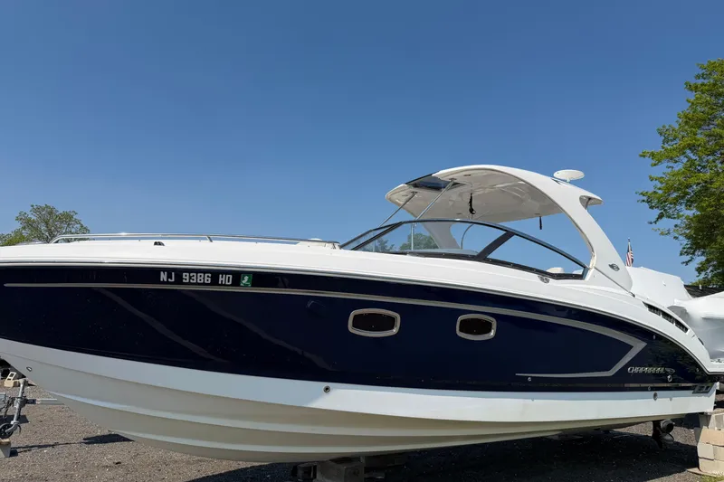The Image of 2012 Chaparral 327 SSX boat on display under clear blue sky. - 0