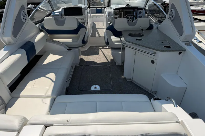 Slide: The Image of Interior of a 2012 Chaparral 327 SSX boat with seating and kitchenette. - 12