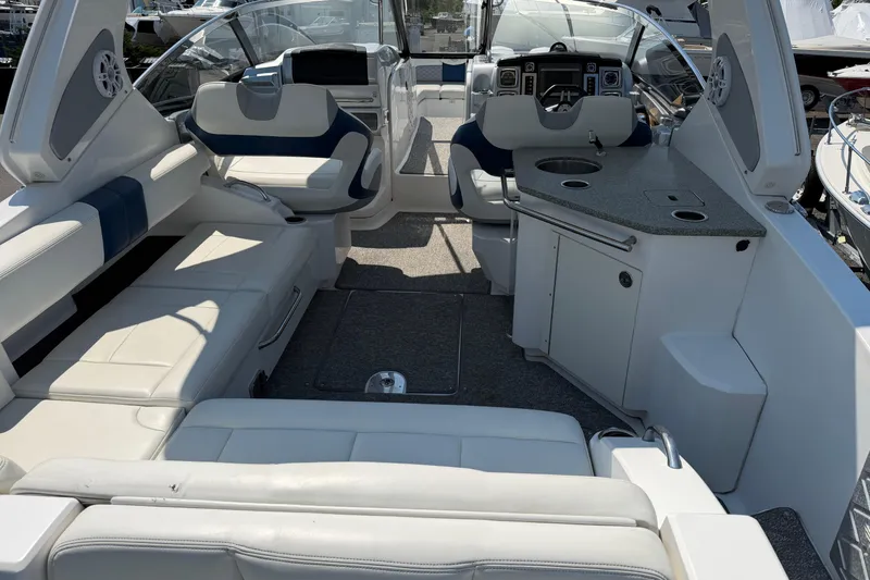 Slide: The Image of Interior of 2012 Chaparral 327 SSX boat with luxurious seating and modern dashboard. - 13