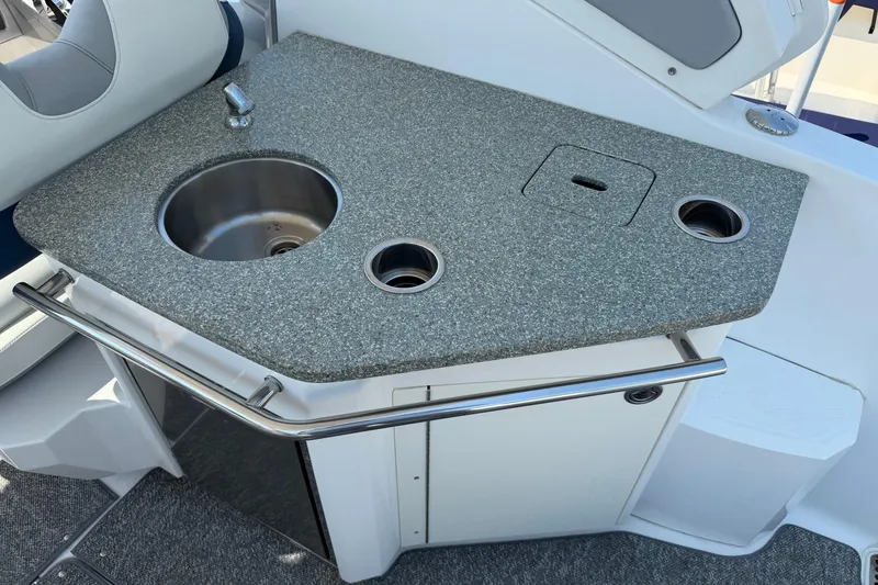 Slide: The Image of 2012 Chaparral 327 SSX boat kitchenette with sink and countertop. - 16