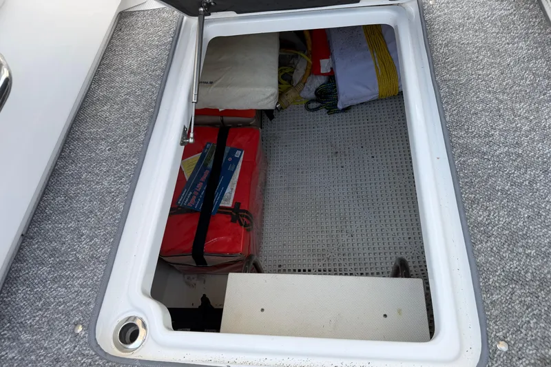 Slide: The Image of Storage compartment on a 2012 Chaparral 327 SSX boat with safety equipment. - 20