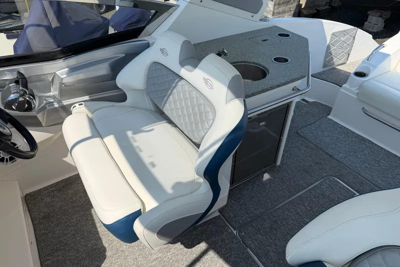 Slide: The Image of Interior of 2012 Chaparral 327 SSX boat with luxurious seating and compact kitchenette. - 25