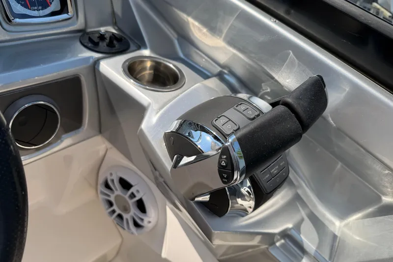 Slide: The Image of Control panel of 2012 Chaparral 327 SSX boat with throttle and cup holder. - 26