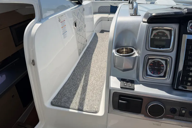 Slide: The Image of Interior view of a 2012 Chaparral 327 SSX boat dashboard with gauges and controls. - 28