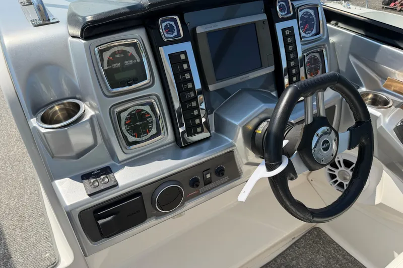 Slide: The Image of Dashboard of a 2012 Chaparral 327 SSX boat with steering wheel and gauges. - 29