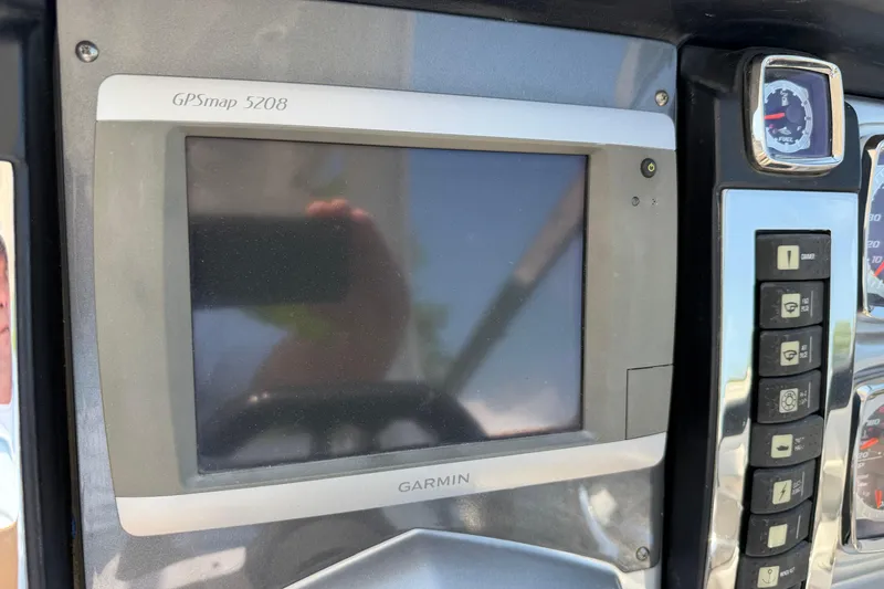 Slide: The Image of Garmin GPSmap 5208 on 2012 Chaparral 327 SSX dashboard with control buttons. - 31