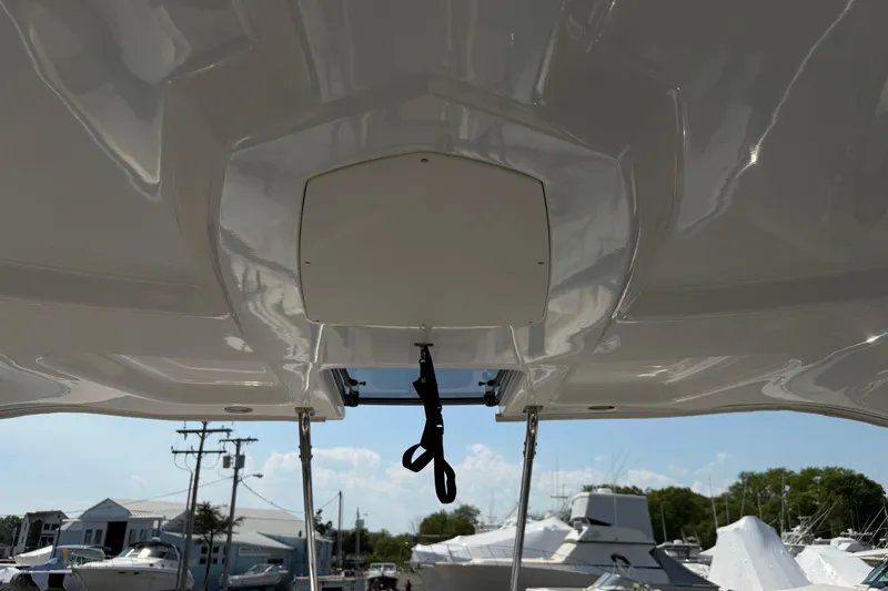 Slide: The Image of 2012 Chaparral 327 SSX boat ceiling view with marina background. - 32