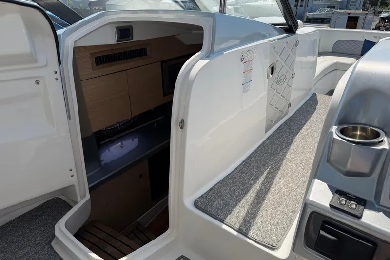 Slide: The Image of Interior view of 2012 Chaparral 327 SSX boat cabin with seating and storage. - 35