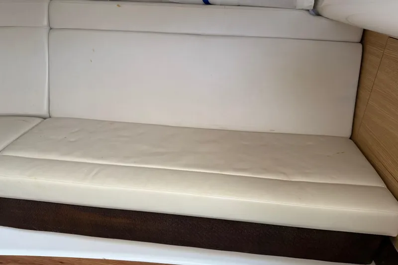 Slide: The Image of White leather seating in a 2012 Chaparral 327 SSX boat interior. - 36