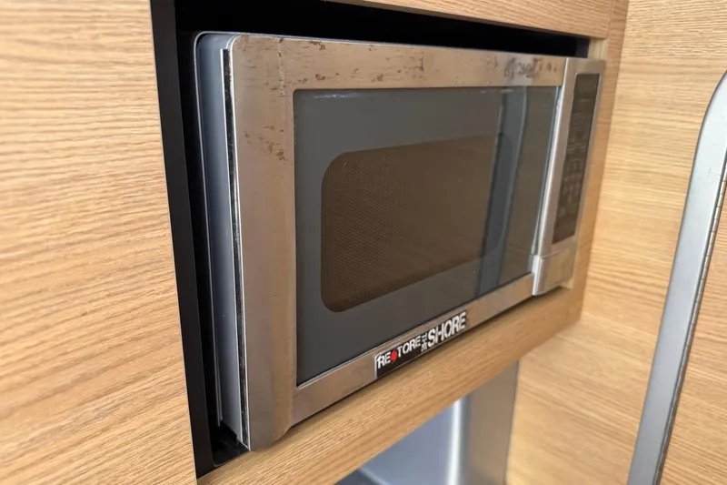 Slide: The Image of Built-in microwave in a 2012 Chaparral 327 SSX boat interior. - 40