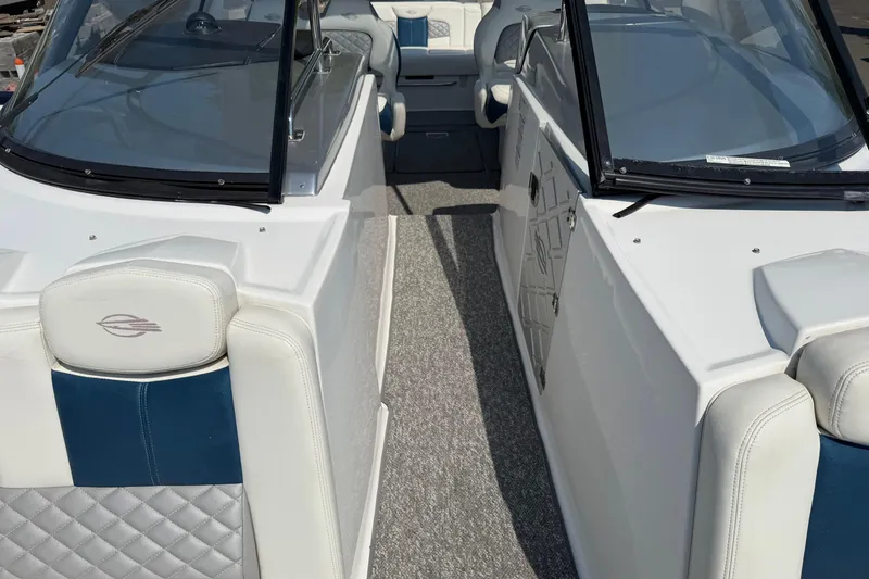 Slide: The Image of 2012 Chaparral 327 SSX boat interior with white and blue seating, dual windshields. - 42
