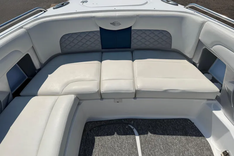 Slide: The Image of 2012 Chaparral 327 SSX boat interior with white cushioned seating. - 43
