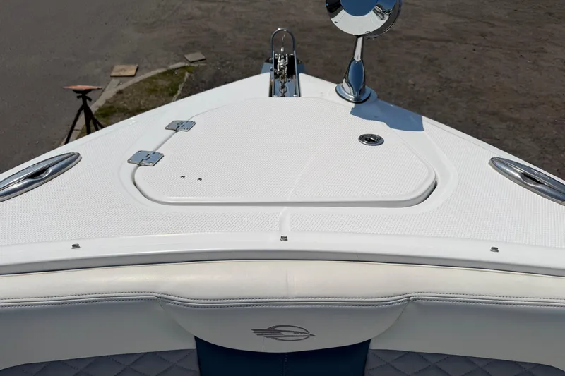 Slide: The Image of Bow view of 2012 Chaparral 327 SSX boat with white deck and chrome details. - 46