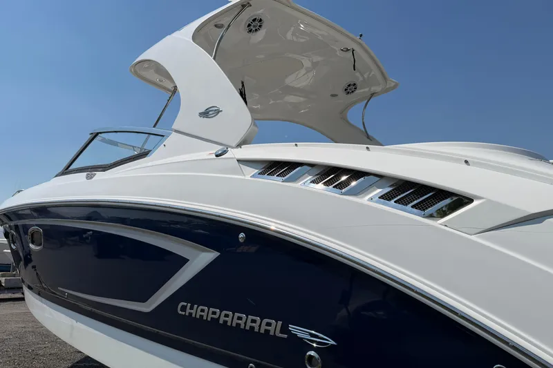 Slide: The Image of Chaparral 327 SSX 2012 boat with sleek design and modern features under clear sky. - 6