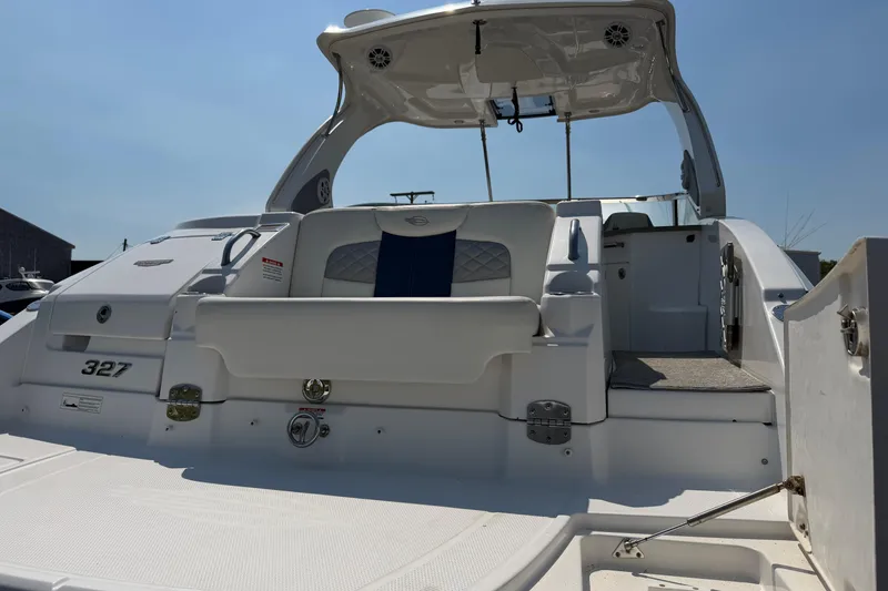 Slide: The Image of 2012 Chaparral 327 SSX boat, rear view, showcasing spacious deck and seating area. - 9