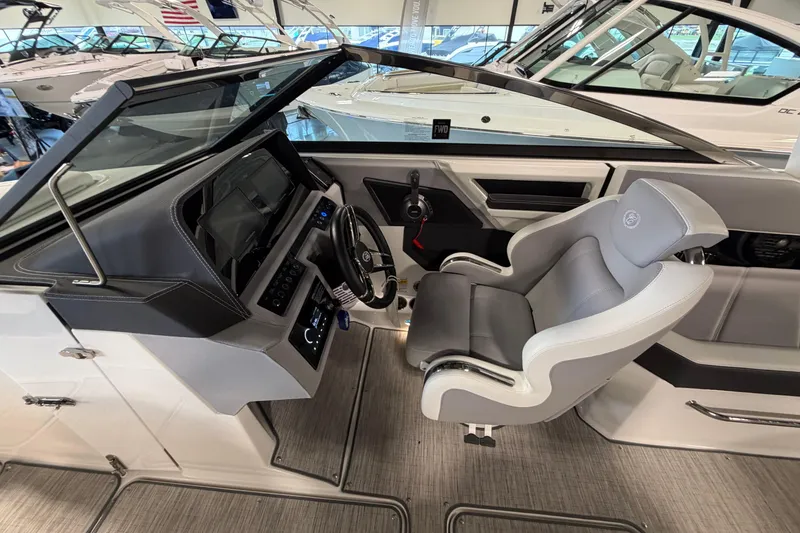 Slide: The Image of 2022 Cobalt R6 Surf boat interior with modern helm and comfortable captain's chair. - 17