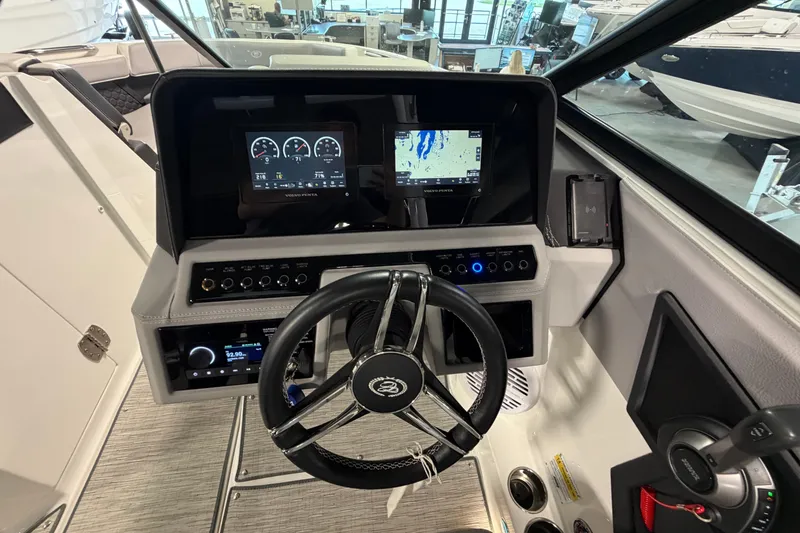 Slide: The Image of 2022 Cobalt R6 Surf boat dashboard with steering wheel and digital displays. - 19