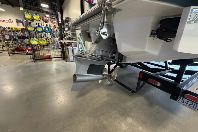 Slide: The Image of 2022 Cobalt R6 Surf boat propeller in a showroom with accessories displayed. - 26
