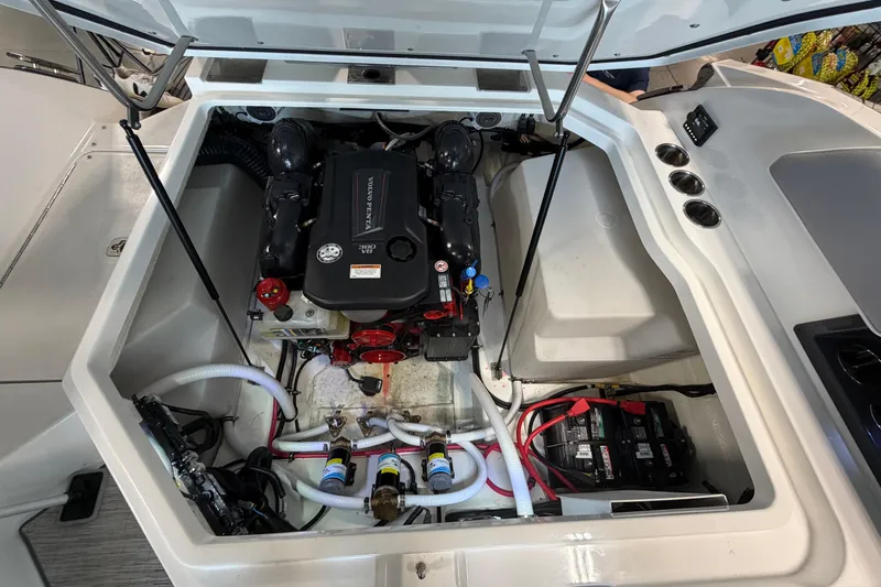 Slide: The Image of Engine compartment of a 2022 Cobalt R6 Surf boat, showcasing Volvo Penta engine. - 28