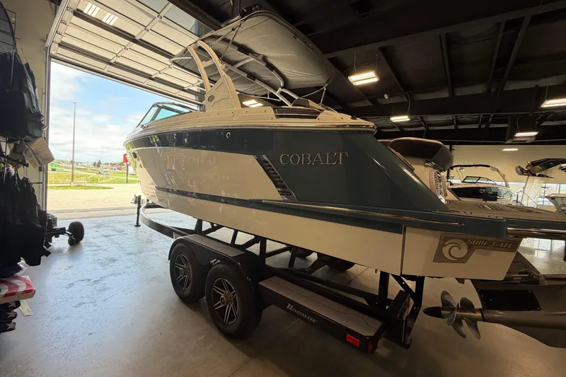Slide: The Image of 2022 Cobalt R6 Surf boat on trailer in showroom, side view. - 4