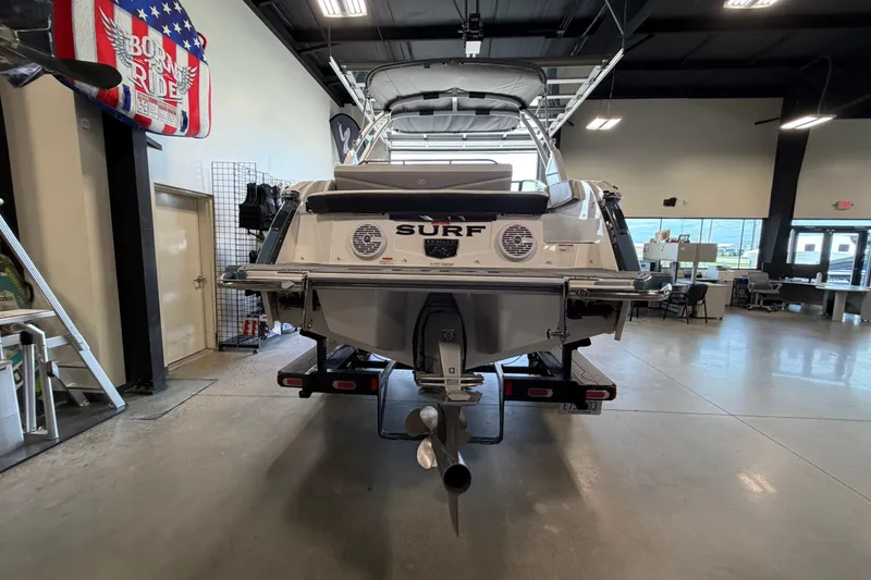 Slide: The Image of 2022 Cobalt R6 Surf boat displayed indoors, rear view with "Surf" branding. - 5
