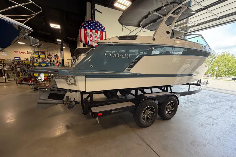 Slide: The Image of 2022 Cobalt R6 Surf boat on trailer in showroom, featuring sleek design and modern features. - 6