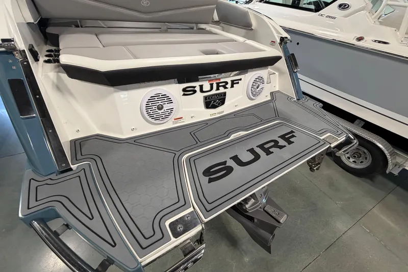 Slide: The Image of 2022 Cobalt R6 Surf boat with custom deck and seating, featuring "Surf" branding. - 7