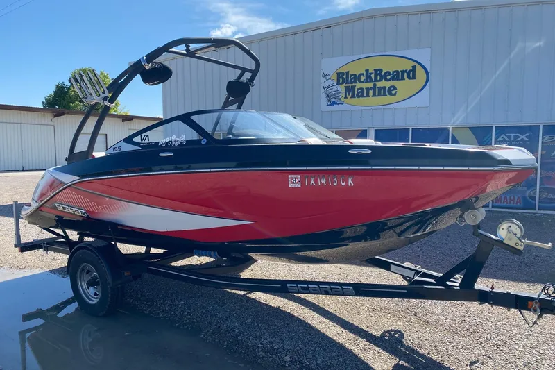 Slide: The Image of 2014 Scarab 195 H.O. Impulse boat in red, displayed at BlackBeard Marine dealership. - 2