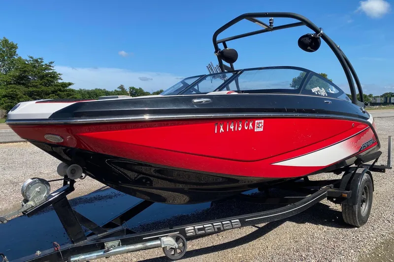 Slide: The Image of 2014 Scarab 195 H.O. Impulse boat in red and black on a trailer. - 3