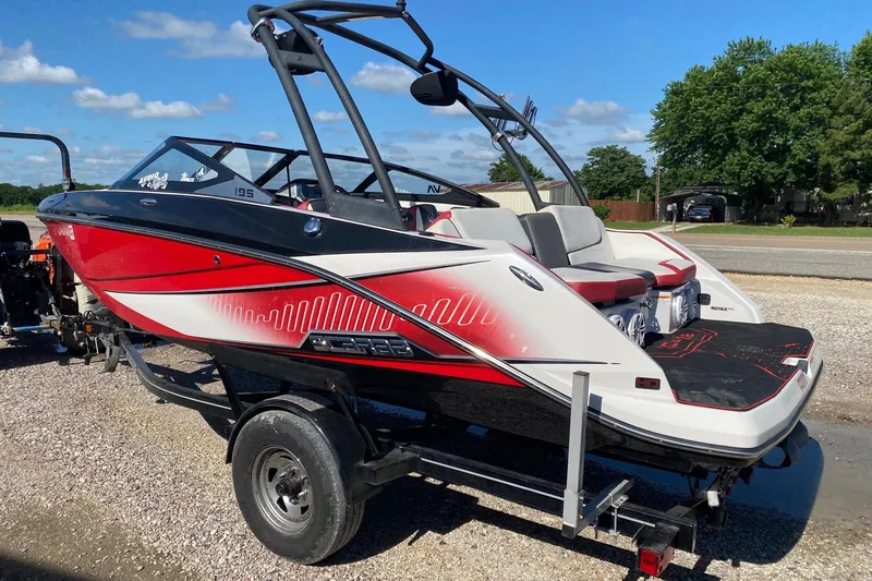 Slide: The Image of 2014 Scarab 195 H.O. Impulse boat on trailer, red and white design, parked outdoors. - 4