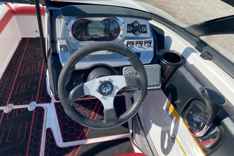 Slide: The Image of Cockpit view of a 2014 Scarab 195 H.O. Impulse boat with steering wheel and controls. - 6
