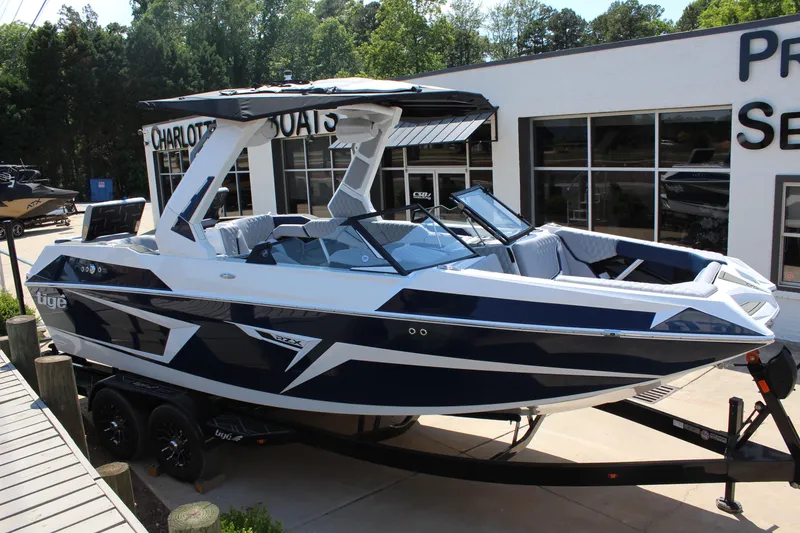 The Image of 2026 Tigé 22RZX boat displayed at dealership, featuring sleek design and modern amenities. - 1