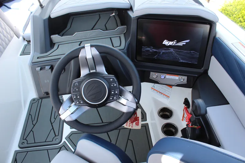Slide: The Image of 2026 Tigé 22RZX boat dashboard with steering wheel and touchscreen display. - 16