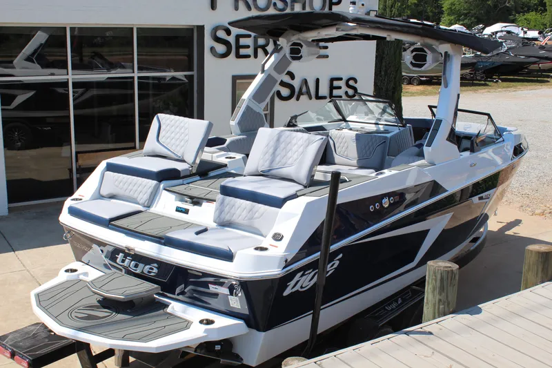 Slide: The Image of 2026 Tigé 22RZX boat displayed at a dealership, featuring sleek design and luxury seating. - 3